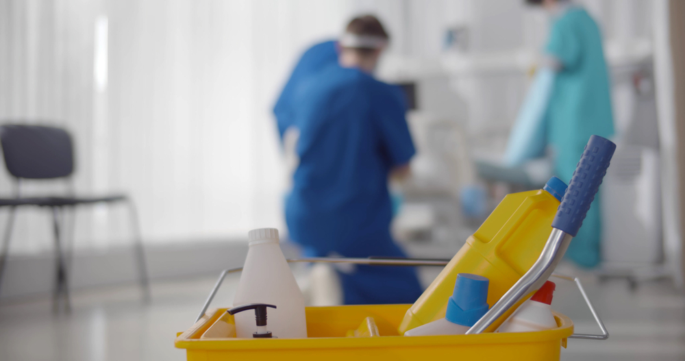 team cleaning ward in hospital on blurred background