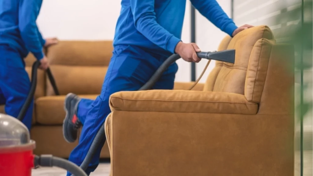Machine upholstery cleaning.Cleaning furniture.Two workers cleaning upholstery