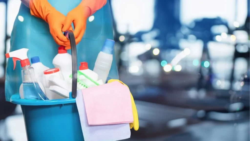 Concept of cleaning services in gyms. Cleaning lady in front of the gym.