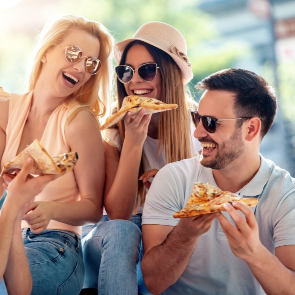 Friends enjoying a day out eating pizza while thier home is cleaned